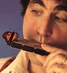 David Harp playing harmonica, with butterfly